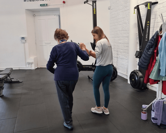 https://staging.healthbyscience.co.uk/wp-content/uploads/2023/01/Untitled-design-4-1.png personal trainer yasemin hyuseinova working with stroke survivor Joyce.