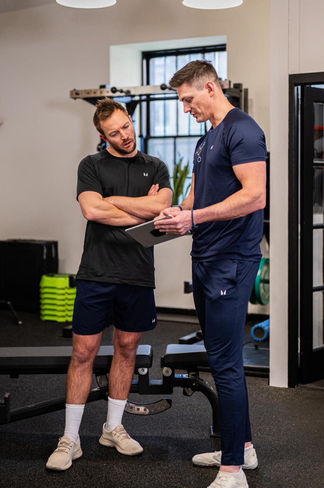 Health by Science founders analyzing clinical data for personal training Edinburgh programs in our Leith gym.