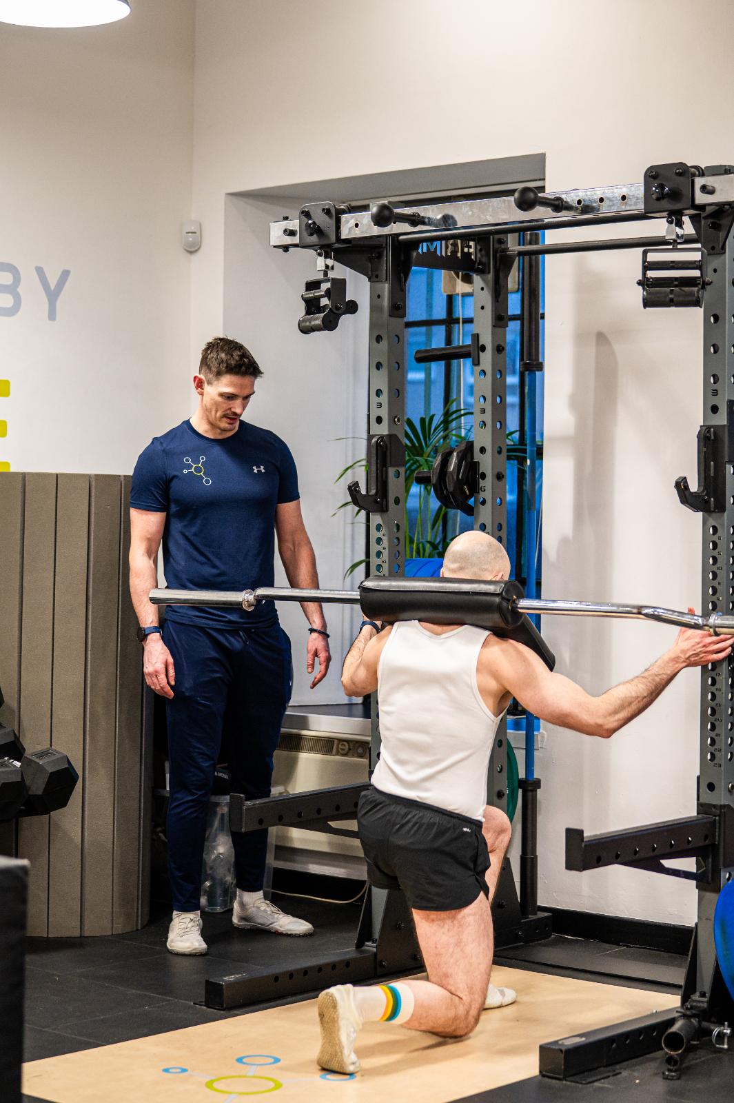 Clinical supervision of a specialized squat assessment using a safety bar for personal training Edinburgh patients in Leith.