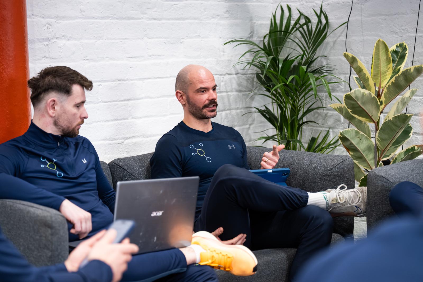 Senior specialist leading a clinical discussion on integrated physiotherapy and personal training Edinburgh services.