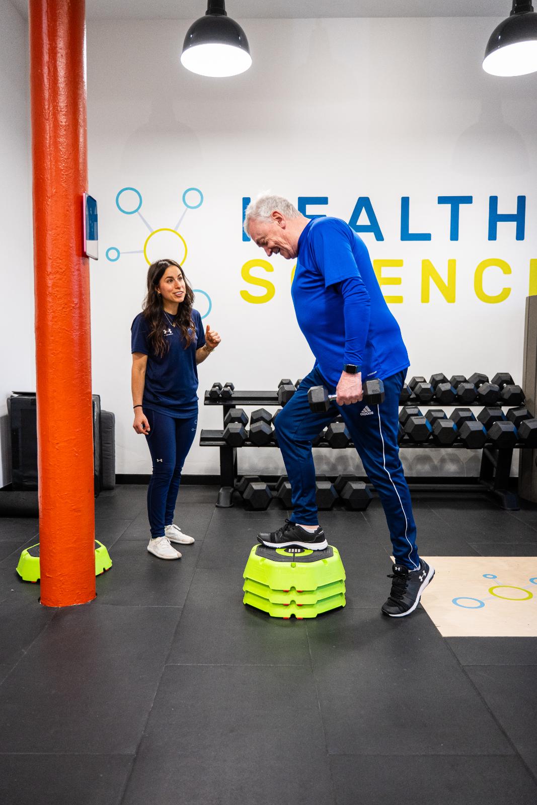 Specialist providing clinical feedback on stepping mechanics during a personal training Edinburgh session at our specialised Leith facility.