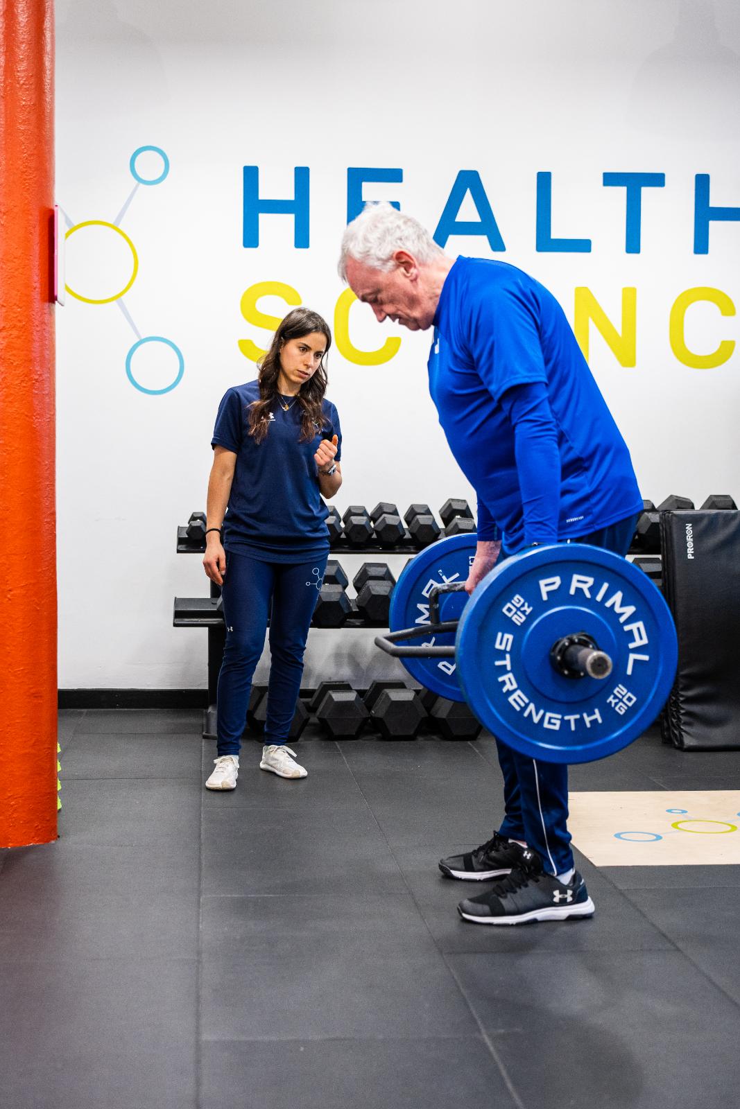 Health by Science coach provide technical cues for a barbell hip hinge movement to support long-term injury prevention.