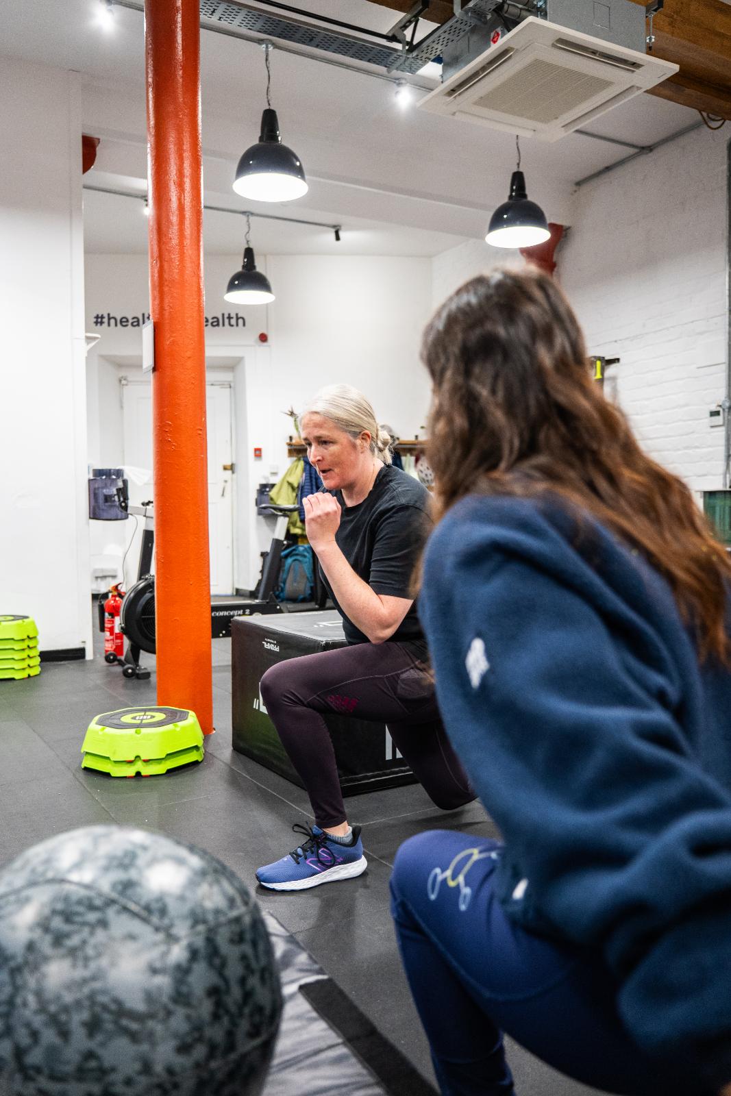 Health by Science specialist providing clinical cues for a lower body rehabilitation exercise in our Leith clinic.