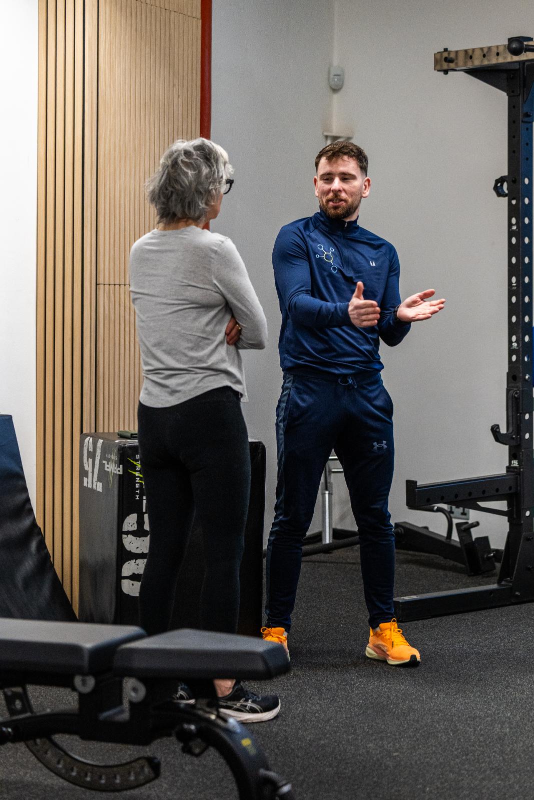 Health by Science practitioner providing expert movement advice and encouragement during a clinical personal training Edinburgh session.