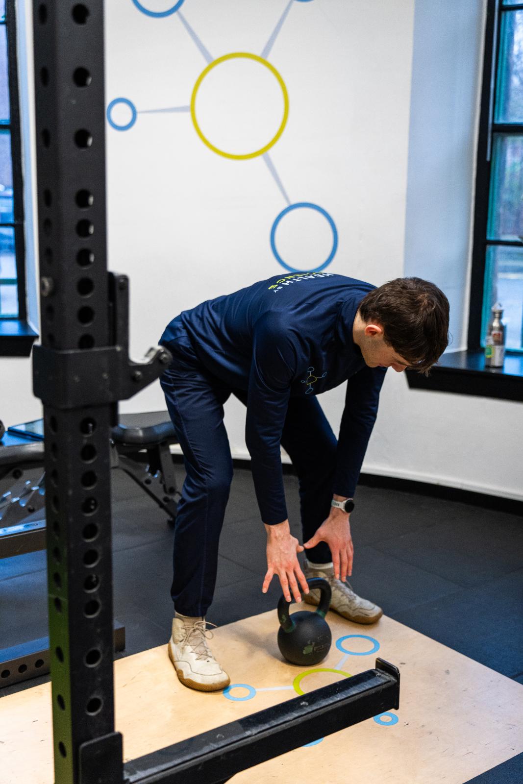 Health by Science practitioner demonstrating optimal kettlebell setup and grip for a data-driven movement assessment in Leith.