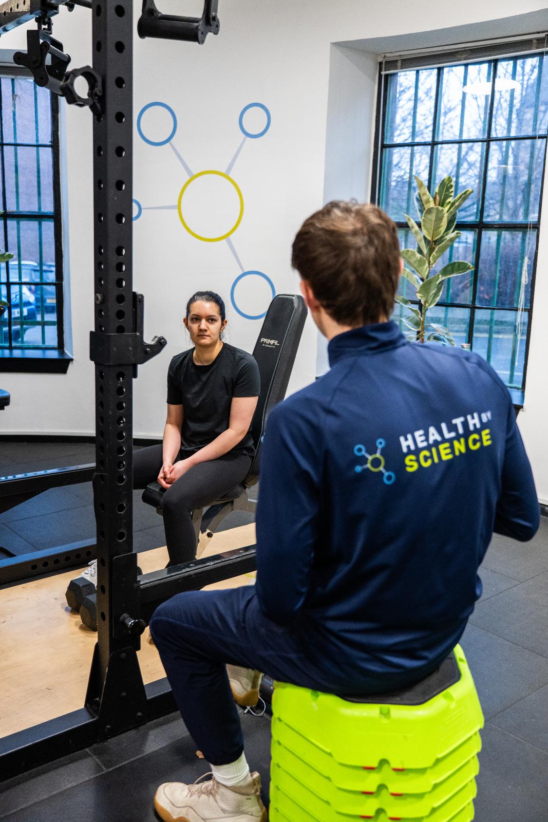 Clinical movement consultation between a Health by Science specialist and a patient at our specialised Leith rehabilitation gym.