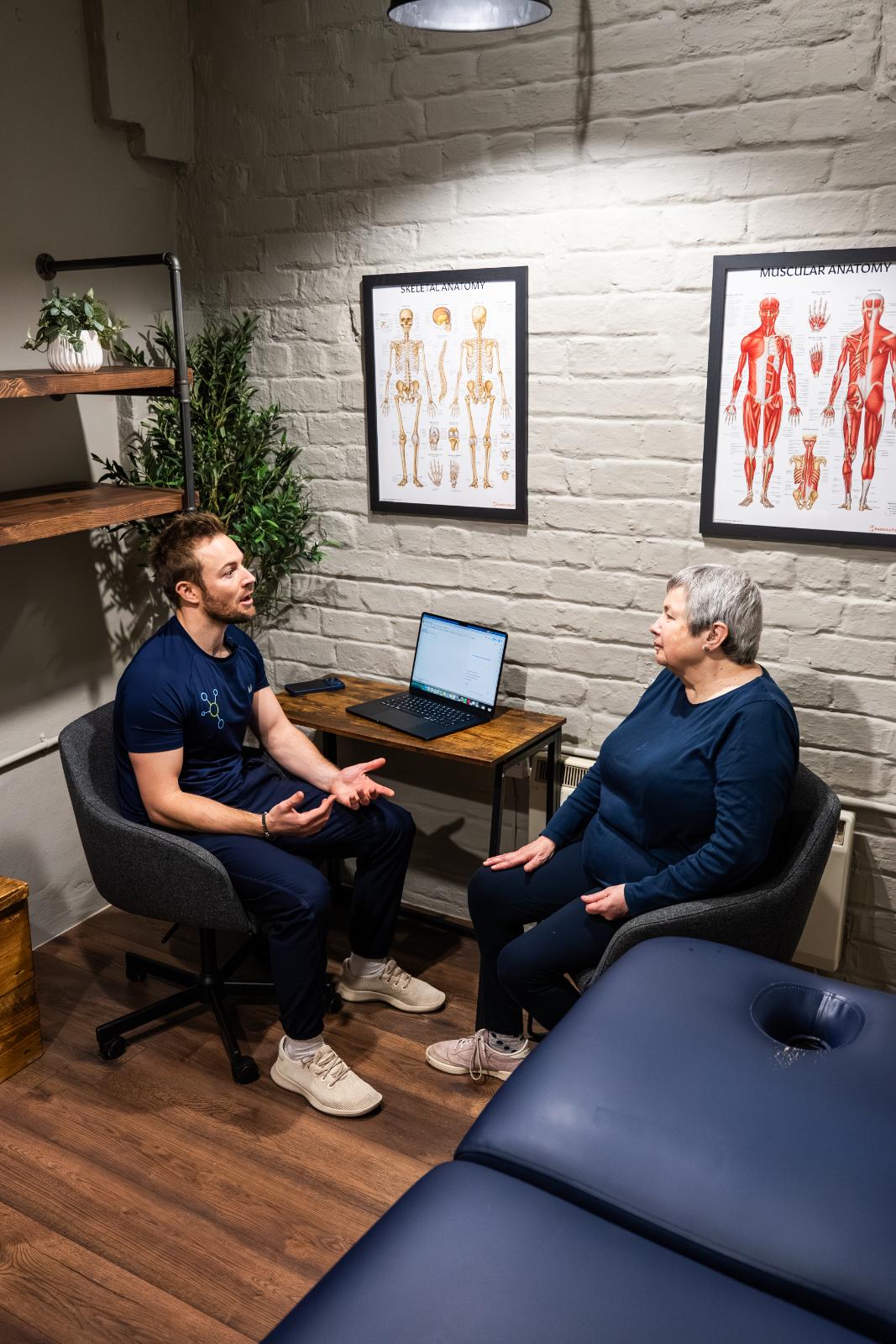 Practitioner and patient reviewing clinical biometric data and long-term health goals during a private consultation in our Edinburgh facility.