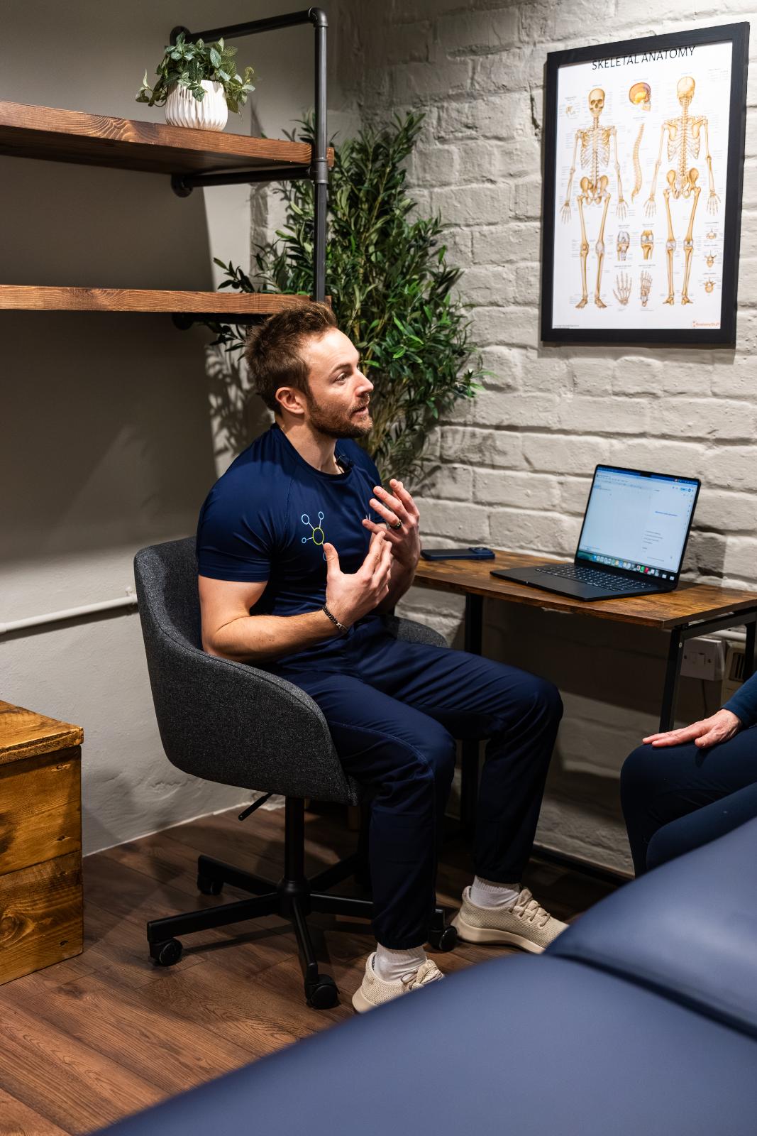 Health by Science specialist engaging in a detailed clinical discussion regarding patient progress and injury rehabilitation in Leith.