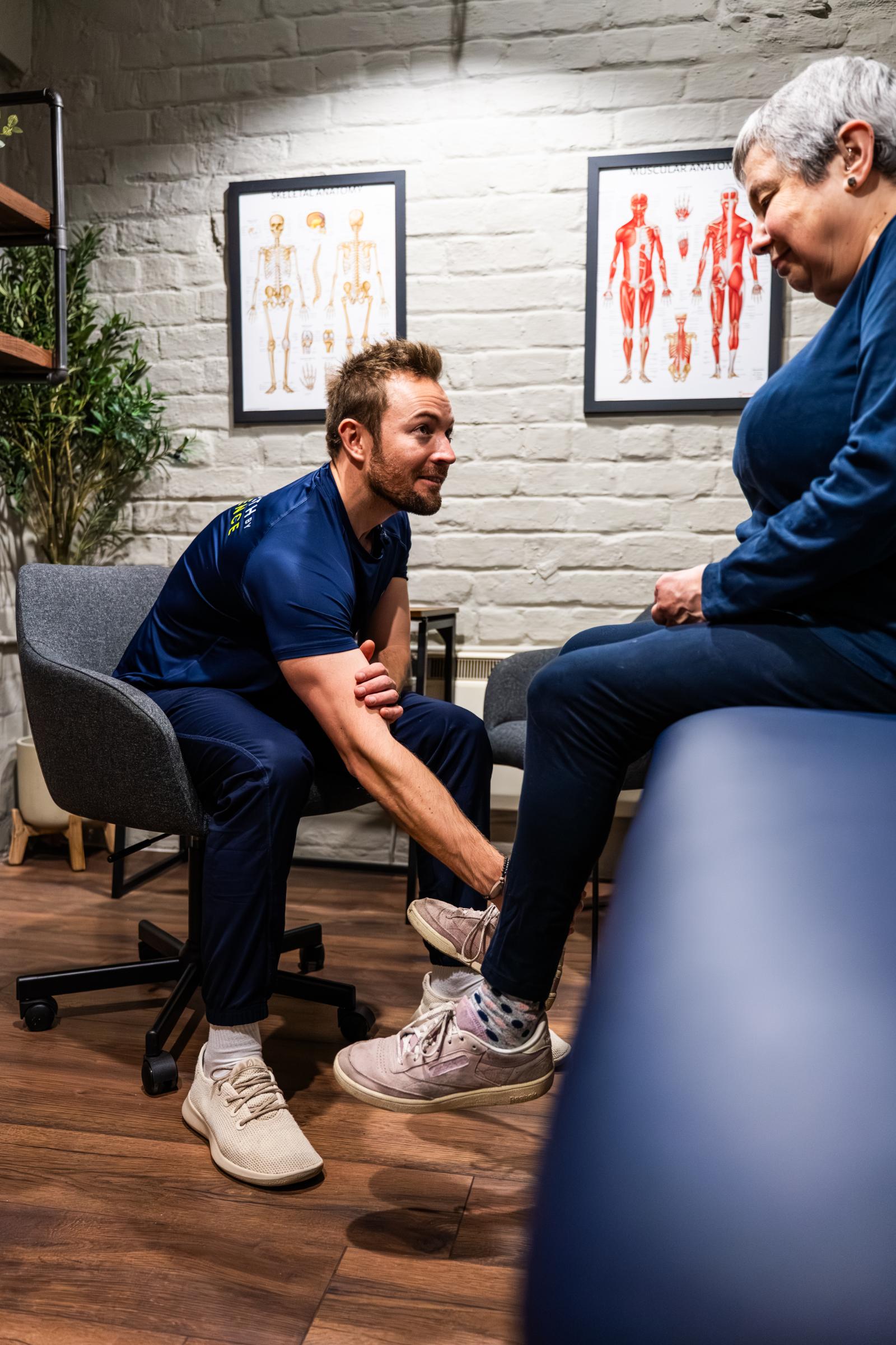 Practitioner conducting a technical physical screening to identify muscular imbalances for evidence-based rehabilitation in Edinburgh.
