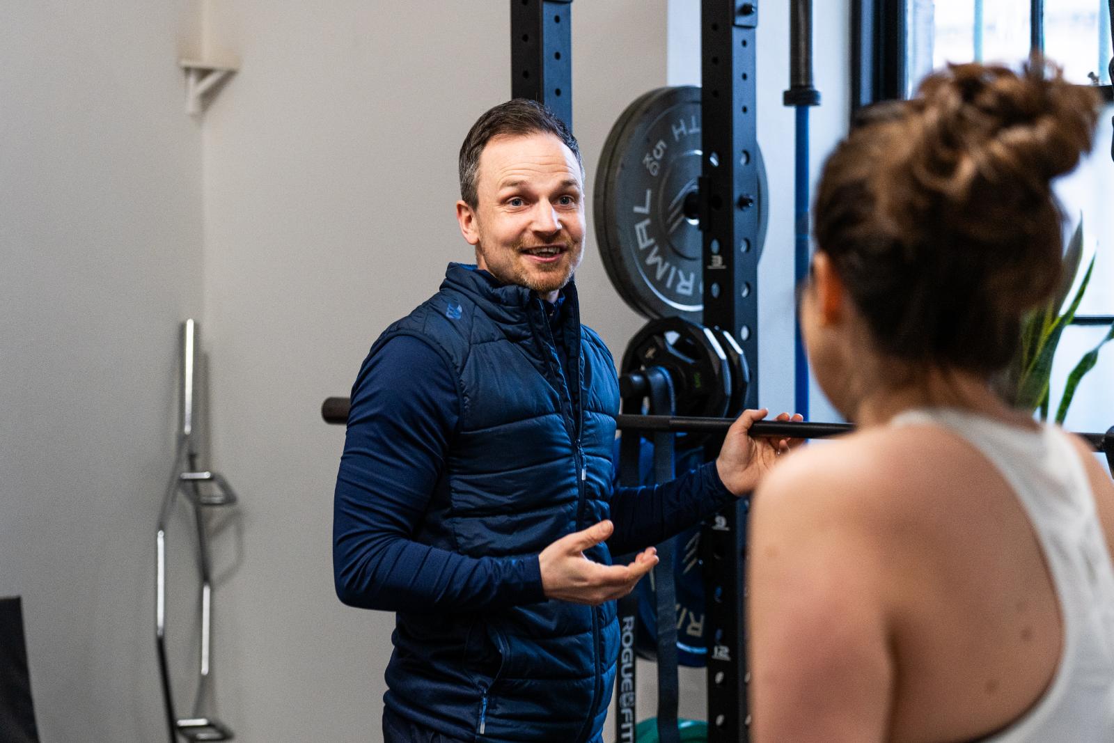 Specialist providing technical movement cues and clinical advice to a personal training Edinburgh client at our Leith lab.