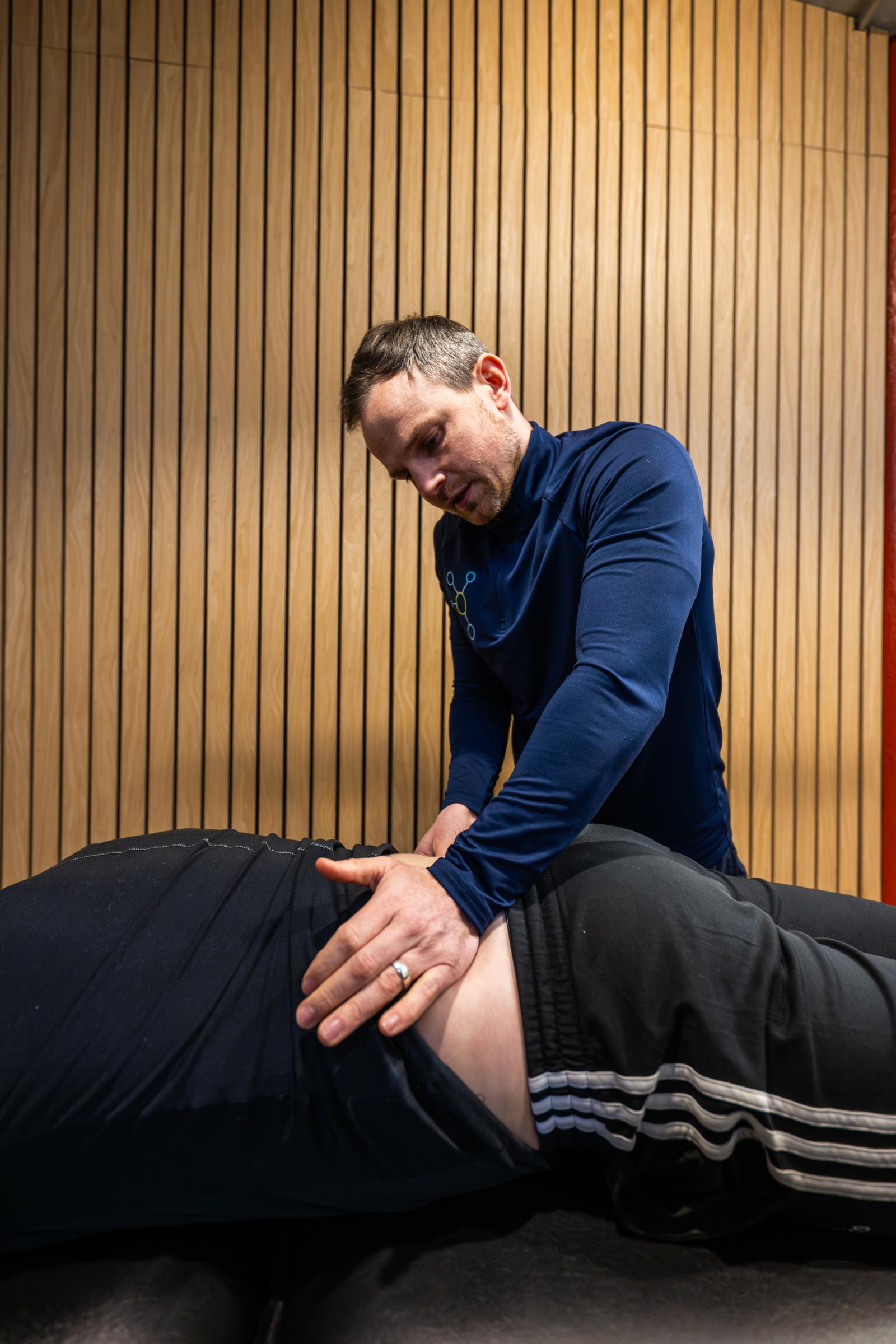 Health by Science specialist providing hands-on manual therapy for lower back pain management in our Edinburgh clinic.