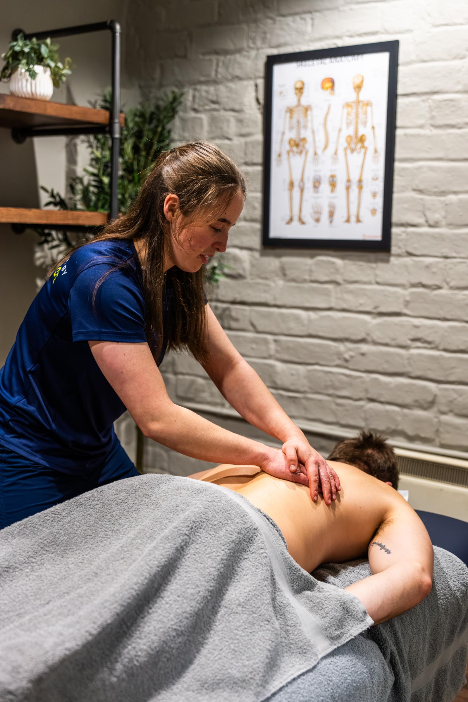 Health by Science specialist performing a clinical sports massage on a patient's lower back to alleviate muscular tension.