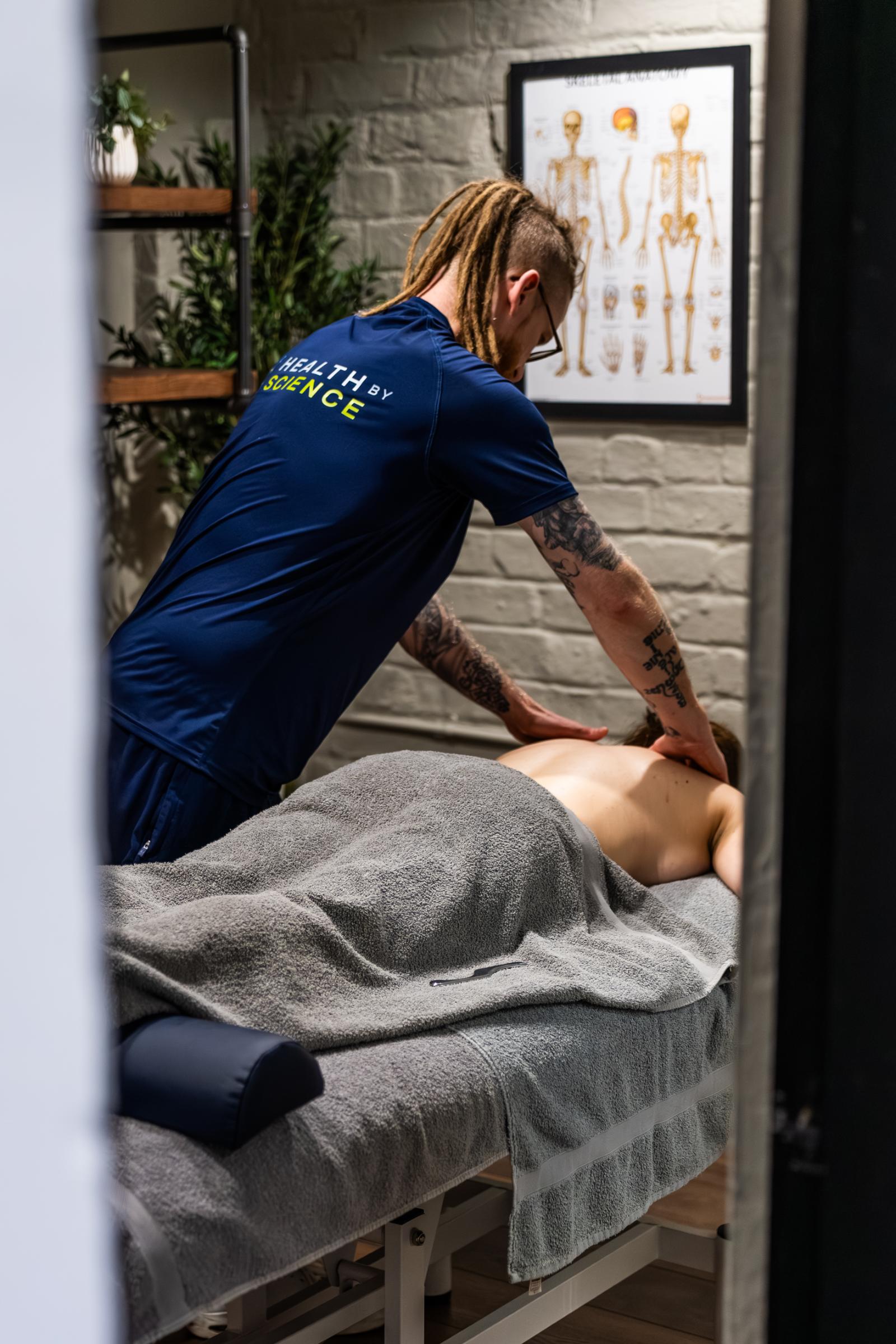 Health by Science specialist performing a clinical sports massage edinburgh on a patient's upper back to relieve muscular tension in Leith.